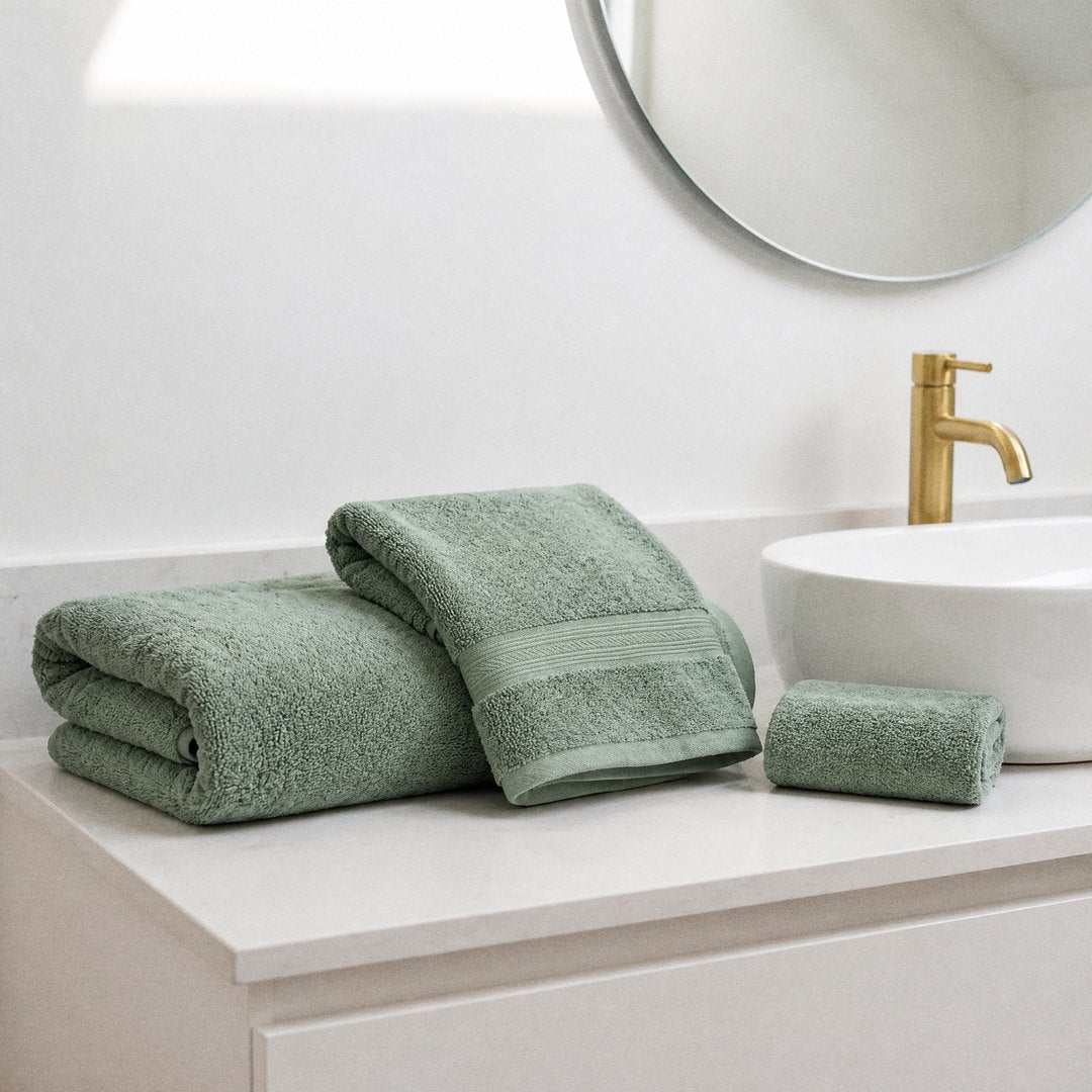 Folded towels on a vanity (Sage)