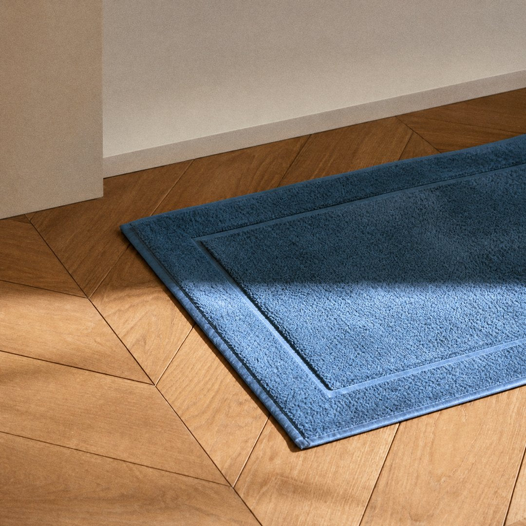 Cotton Bath Mat on the bathroom floor (Lapiz Blue)
