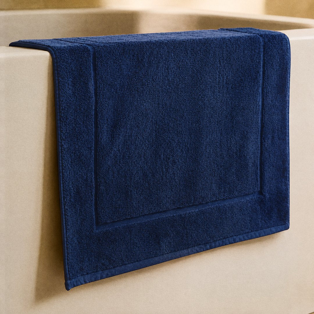 Cotton Bath Mat on the bathroom floor (Navy Blue)