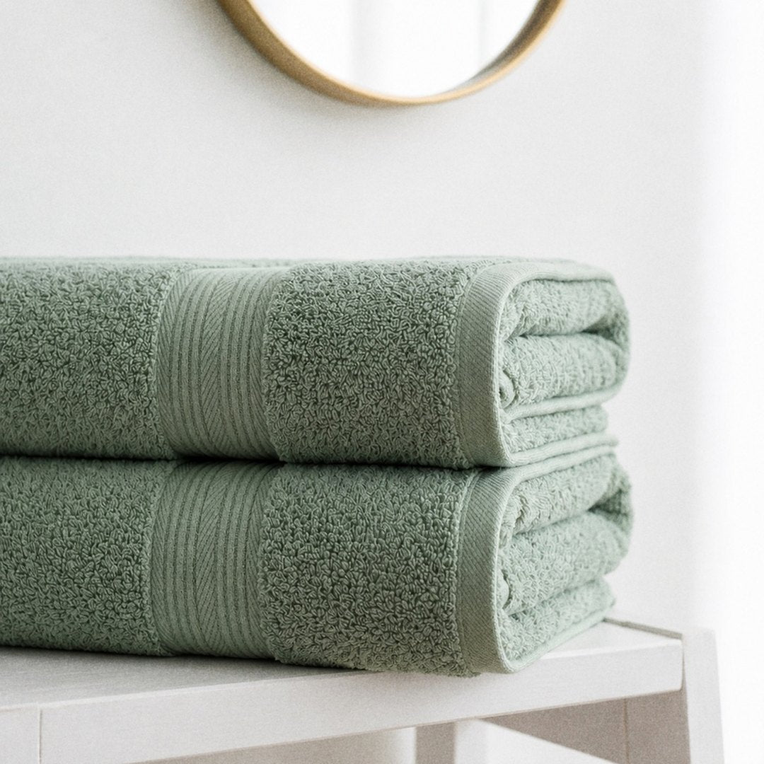 Folded towels on a white stool (Sage)